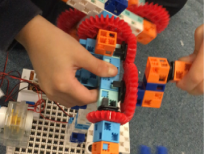 Students were trying to change the speed of their Ferris Wheel by adjusting the gears.
